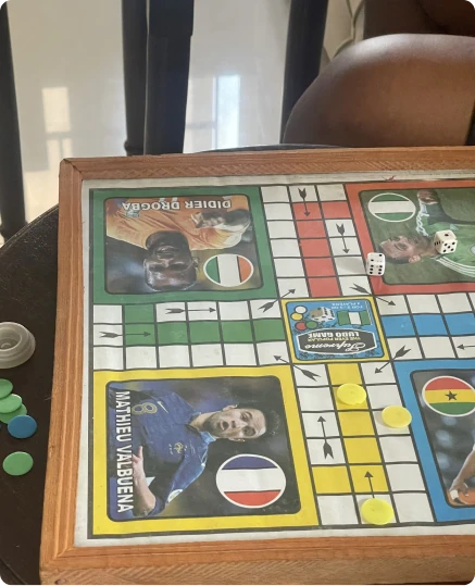 A Ludo board game with football player portraits in the corners