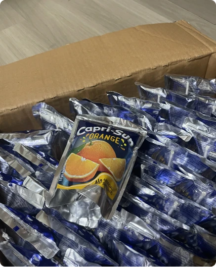 A box full of Capri-Sun orange juice pouches